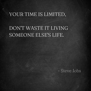 May include: A monochrome image featuring the quote "YOUR TIME IS LIMITED, DON'T WASTE IT LIVING SOMEONE ELSE'S LIFE." by Steve Jobs. The white text is set against a dark, textured backdrop, creating a stark contrast.