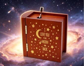 Libro "Te amo hasta la luna y de vuelta" con caja de música de madera con manivela