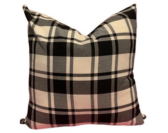 May include: Black and white checked throw pillow. The pillow is made of a soft, comfortable fabric and has a classic checked pattern.