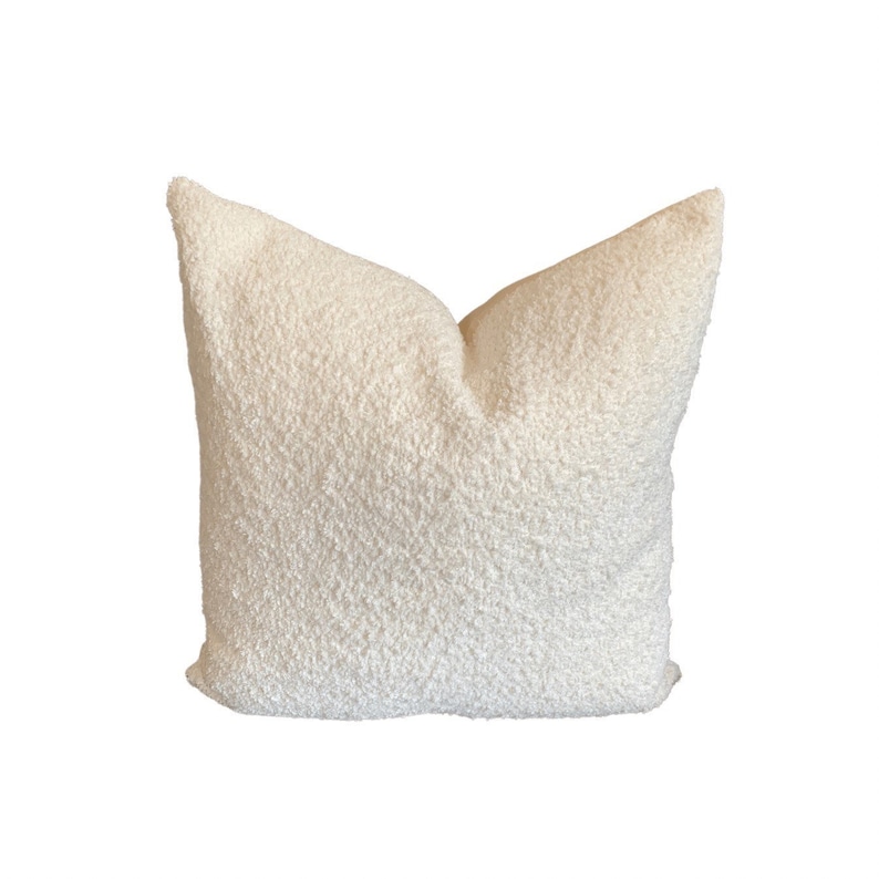 May include: A white fluffy pillow with a soft, textured surface.