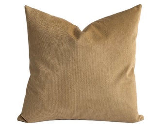 May include: A brown corduroy throw pillow with a subtle ribbed texture.