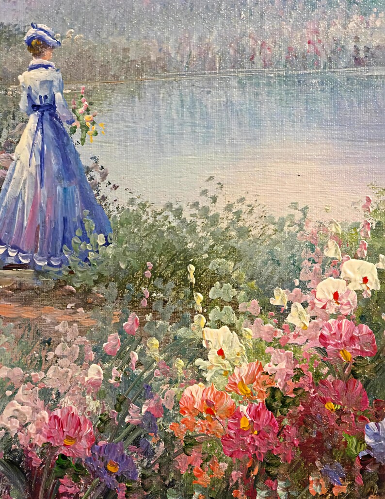 May include: An impressionistic painting depicts a woman in a blue dress and hat, standing near a lake. The foreground features a vibrant array of colorful flowers in shades of pink, red, orange, and white. The artwork evokes a serene, natural scene.