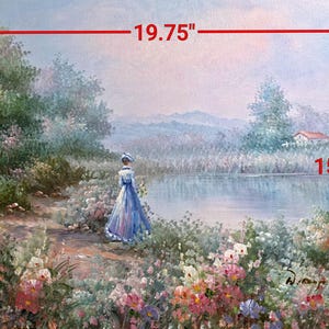 May include: A landscape painting depicting a woman in a blue dress standing near a lake. The artwork, measuring 19.75 x 15.75 inches, features a serene scene with colorful flowers, trees, and a distant house.