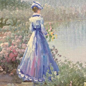 May include: Oil painting of a woman in a long blue dress and hat, standing near a body of water. She holds a bouquet of yellow flowers. The painting has a soft, impressionistic style with pink and green foliage.