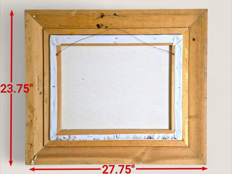 May include: Back of a framed painting. The wooden frame is rectangular, measuring 27.75 inches wide and 23.75 inches tall. The canvas is white, and the frame is a light brown color. The canvas is secured to the frame with staples.