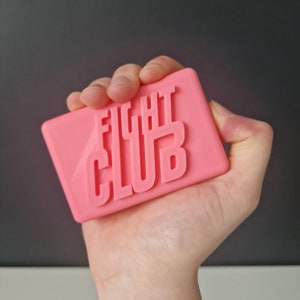 May include: A pink soap bar with the words "FIGHT CLUB" embossed on the front.