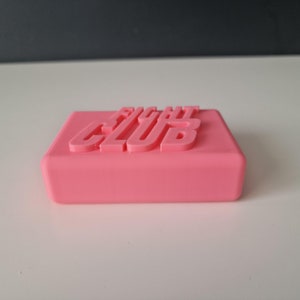 May include: A pink soap bar with the words "Fight Club" embossed on the top.