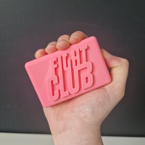 May include: A pink soap bar with the words "Fight Club" embossed on it.