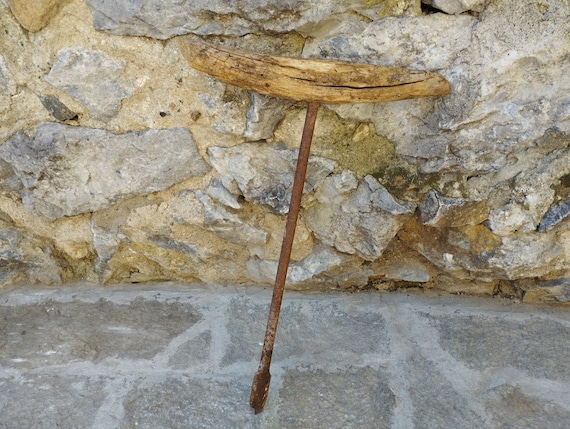 An antique-style hand-forged decorative drill bit that doubles as man-cave wall art — functional industrial sculpture with genuine aged character.