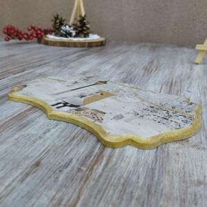 May include: A decorative wooden coaster with a gold trim and a white background. The coaster features a design of a bird with a heart and the words "with love".
