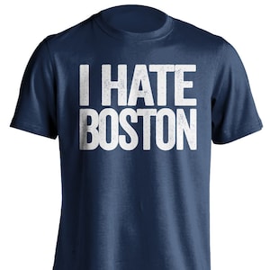 May include: A navy blue t-shirt with the text "I HATE BOSTON" printed in white on the front.