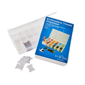 May include: A clear plastic embroidery thread organiser with a blue and white box. The box reads "Embroidery Thread Organizer" and includes 50 paper bobbins. The organiser is designed to keep thread clean and tangle-free.