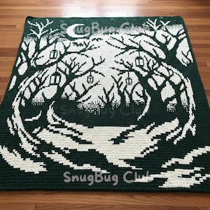May include: A dark green and white crocheted blanket featuring a forest scene with trees, lanterns, and a crescent moon. The blanket has the text "SnugBug Club" in the bottom corner. The design is a pixelated style.
