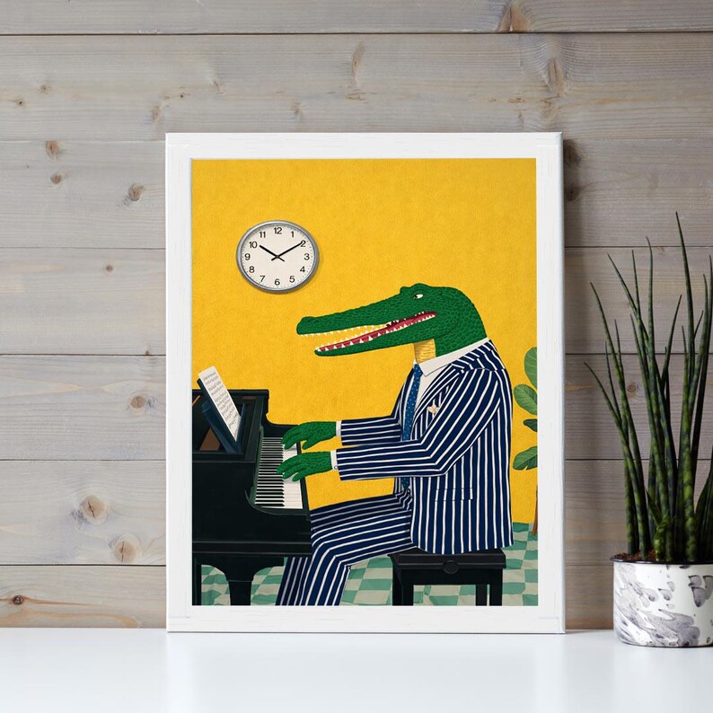 May include: A framed art print featuring an alligator playing a black piano. The alligator is wearing a blue and white striped suit and tie. A clock is on the yellow wall. The print is in a white frame.