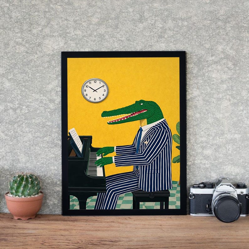 May include: A framed art print featuring an alligator playing a grand piano. The alligator is wearing a blue and white striped suit and tie. A clock is visible in the upper left corner. The background is yellow.