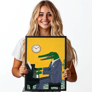 May include: Framed art print featuring a green alligator playing a black piano. The alligator wears a blue and white striped suit and tie. A clock is on the yellow background. The art print is in a black frame.