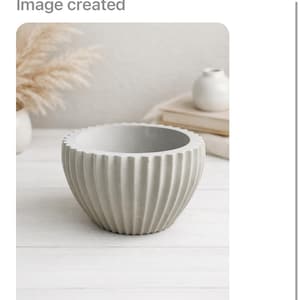 May include: A gray, ribbed concrete bowl. The bowl has a rounded shape with vertical ridges. The image also contains text that says "Create photo to sell on Etsy" and "Image created".