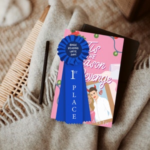 May include: A blue ribbon with the words "1st Place" and "Binge Reading Until 3AM" on it, placed on a pink book with the title "Tis the Season Revenge" and the author's name "ELIZABETH".