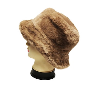 May include: A brown faux fur bucket hat with a wide brim.