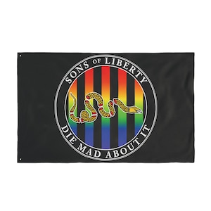 May include: Black flag featuring a circular emblem with a rainbow striped background and a coiled snake. The emblem reads "SONS OF LIBERTY" and "DIE MAD ABOUT IT" in white text. The snake is yellow with red accents.