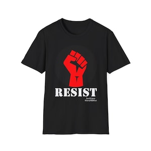 May include: Black t-shirt with a red raised fist graphic and the word "RESIST" in white letters. The text below the graphic reads "Sons Of Liberty #Liberty775Official"