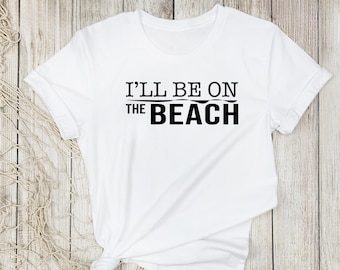 May include: White t-shirt with black text that reads "I'll be on the beach".