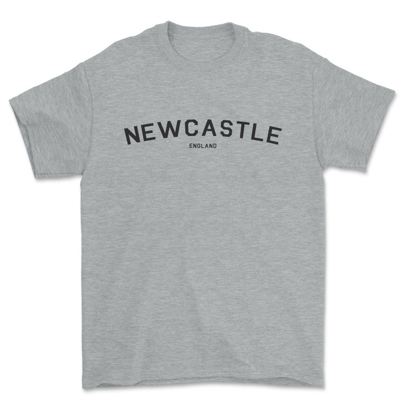 May include: A heather gray t-shirt with black text that reads "NEWCASTLE ENGLAND".
