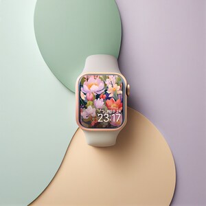 May include: A white and rose gold Apple Watch with a floral watch face that reads "WED 24 23:17".
