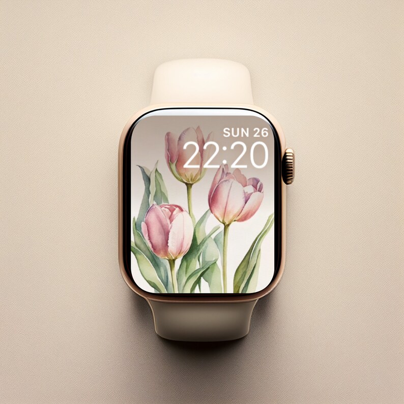 May include: A white Apple Watch with a gold band and a pink floral watch face. The watch face displays the time as 22:20 and the date as SUN 26.