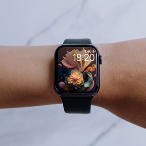 May include: A black Apple Watch with a floral watch face that reads "THU 9 18:20" on a person's wrist.