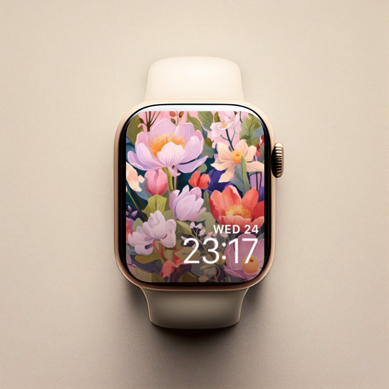 May include: A gold Apple Watch with a white band and a floral watch face. The watch face displays the time as 23:17 and the day as Wed 24.