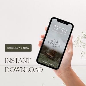 May include: A black smartphone with a white background displaying a phone lock screen with the text "I AM EXACTLY WHERE I NEED TO BE" and the time "12:42" with the date "Saturday, January 22".