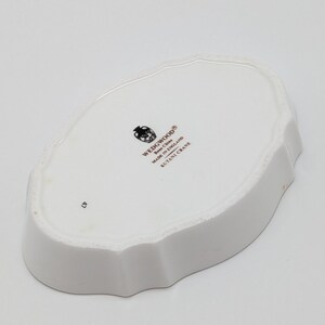 May include: White ceramic dish with a scalloped edge. The underside features the Wedgwood logo, "Bone China Made in England," and "Kutani Crane." The number "47" is printed on the dish.