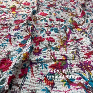 May include: White fabric with a vibrant floral and bird pattern. The design features red, pink, purple, yellow, and teal elements. The fabric is stitched with a quilted texture, and the text "copyright of ruhicollection" is visible.