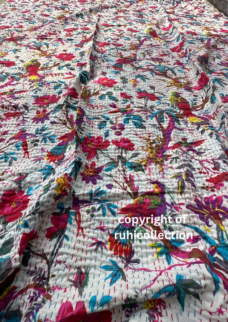 May include: White fabric with a vibrant floral and bird pattern. The design features red, pink, purple, yellow, and teal elements. The fabric is stitched with a quilted texture, and the text "copyright of ruhicollection" is visible.
