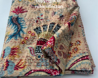 May include: A beige kantha quilt with a floral pattern in shades of red, blue, and yellow. The quilt is folded in half and has a hand-stitched design.
