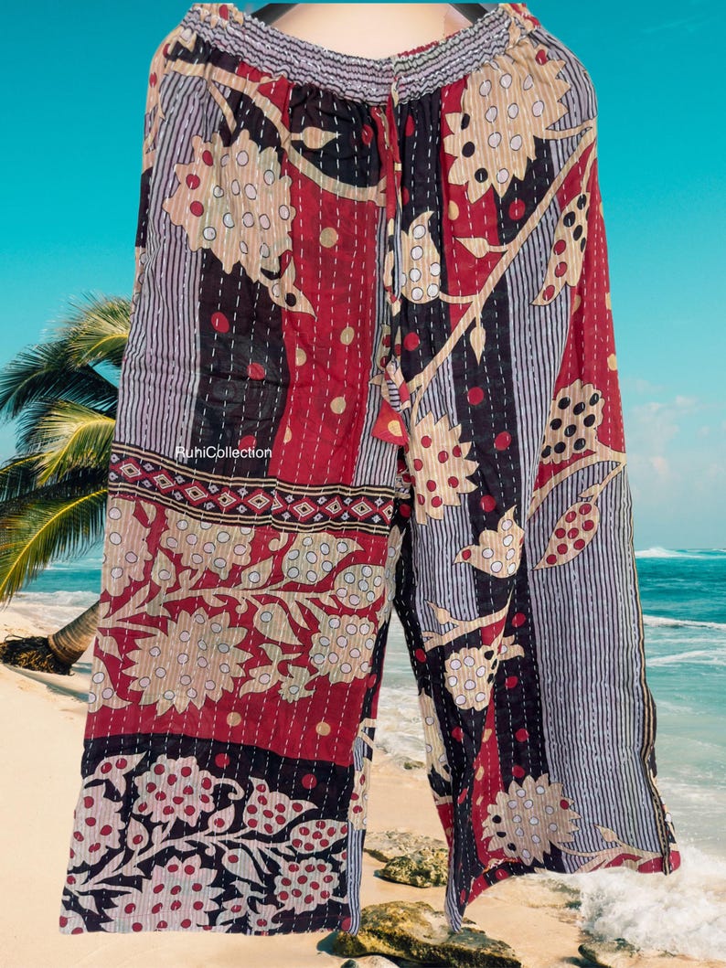 May include: Red, black, and white patterned pants with a drawstring waist. The pants are made of a soft, lightweight fabric and have a relaxed fit.