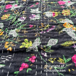 May include: Black fabric with a floral pattern in shades of pink, green, white, and yellow. The fabric is quilted with white stitching. The text "copyright of ruhicollector" is visible in the bottom right corner.