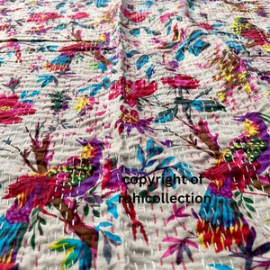 May include: Beige textile with a vibrant floral and bird pattern. The design features colorful birds, flowers, and leaves in shades of pink, blue, purple, and yellow. The text "copyright of rahicollection" is visible.