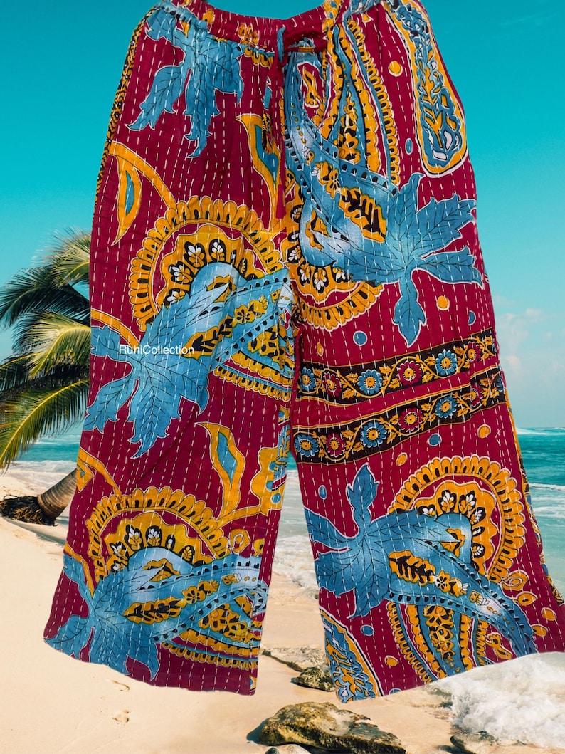May include: Red, blue, and yellow patterned wide-leg pants with a drawstring waist. The pants are made of a soft, lightweight fabric and have a relaxed fit.