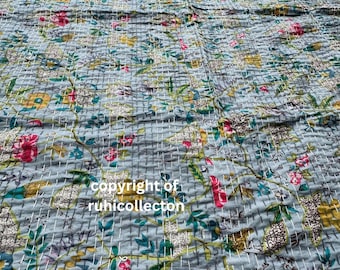 May include: A light blue floral quilt with a repeating pattern of flowers and leaves in shades of pink, yellow, and green. The quilt has a stitched texture and the text "copyright of ruhicollecton".