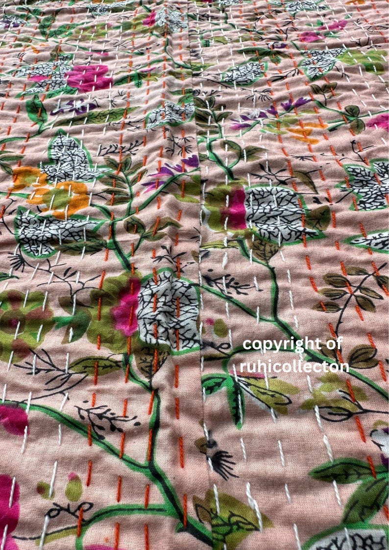 May include: A close-up of a pink fabric with a floral pattern. The fabric is quilted with white and orange thread. The text "copyright of ruhicollecton" is visible in the bottom right corner.