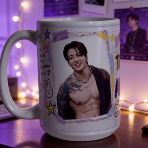 May include: A white ceramic mug featuring a photographic print of a person with dark hair, a silver chain necklace, and visible arm tattoos. The design includes decorative elements like stars, a rabbit, and the text you make the brighter days.