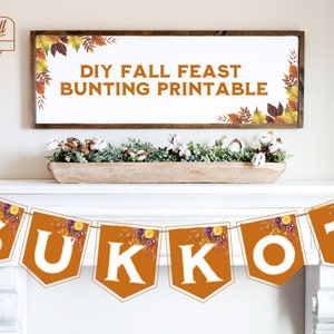 May include: A brown and orange banner with the word "SUKKOT" in white letters. The banner has a floral design with autumn colours. The banner is hanging on a white mantel.
