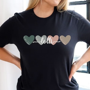 May include: Black t-shirt with four colorful hearts and the word "lolli" in white text.
