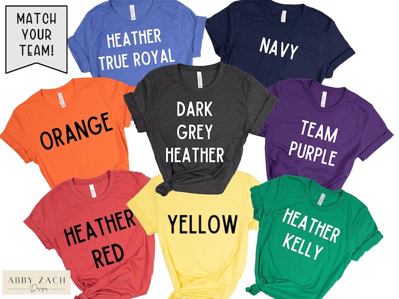 May include: Ten different coloured t-shirts with various text printed on them. The text includes "Match Your Team!" "Heather True Royal", "Orange", "Dark Grey Heather", "Yellow", "Navy", "Team Purple", "Heather Red", and "Heather Kelly".