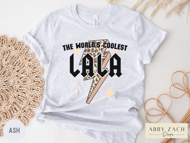 May include: A gray t-shirt with the text "The World's Coolest Lala" in black letters with a leopard print lightning bolt graphic.