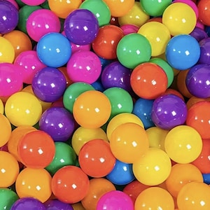 May include: A close-up shot of a pile of colorful plastic balls. The balls are in various colors, including pink, purple, blue, green, yellow, and orange. The balls are smooth and shiny, and they are all the same size. The image is well-lit and the colors are vibrant.