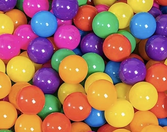 May include: A close-up shot of a pile of colorful plastic balls. The balls are in various colors, including pink, purple, blue, green, yellow, and orange. The balls are smooth and shiny, and they are all the same size. The image is well-lit and the colors are vibrant.