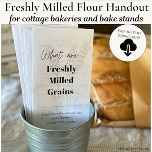 May include: A stack of white paper handouts titled What are Freshly Milled Grains with a wheat illustration, placed in a small metal bucket. The text includes Health benefits, uses and the reason behind Freshly Milled grains and an Easy Instant Download icon.